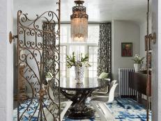 Ornate Metal Gate Door Opens to Eclectic Dining Room
