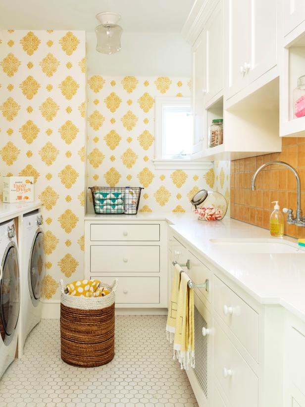 Yellow patterned wallpaper and matching towels and accessories make this a heavenly place to do laundry