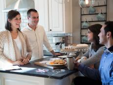 Homeowners Entertaining Guest in New Kitchen 