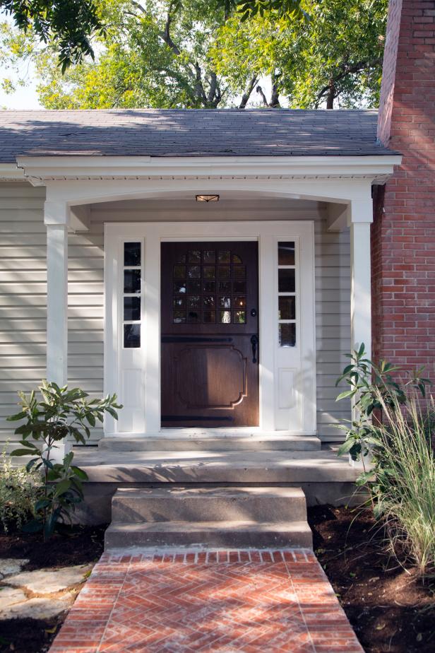 After of Exterior With Gray Siding, Dark Brown Door & Brick Walkway