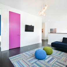 Modern Family Room With Bright Pink Door