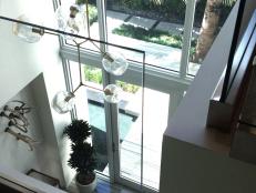 A Modern Chandelier Hangs in Sunny Foyer 