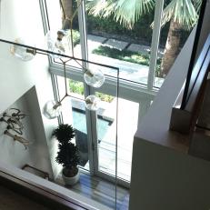 A Modern Chandelier Hangs in Sunny Foyer 