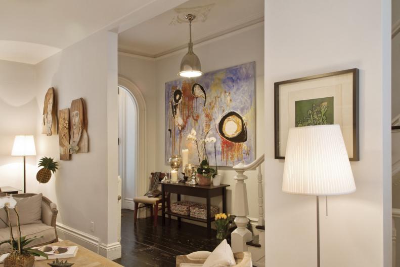 White Foyer With Metallic Pendant, Small Console, Large Art