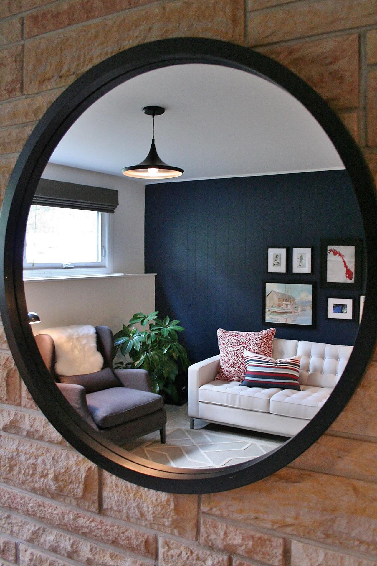 Round Mirror Reflecting Blue Contemporary Living Room | HGTV