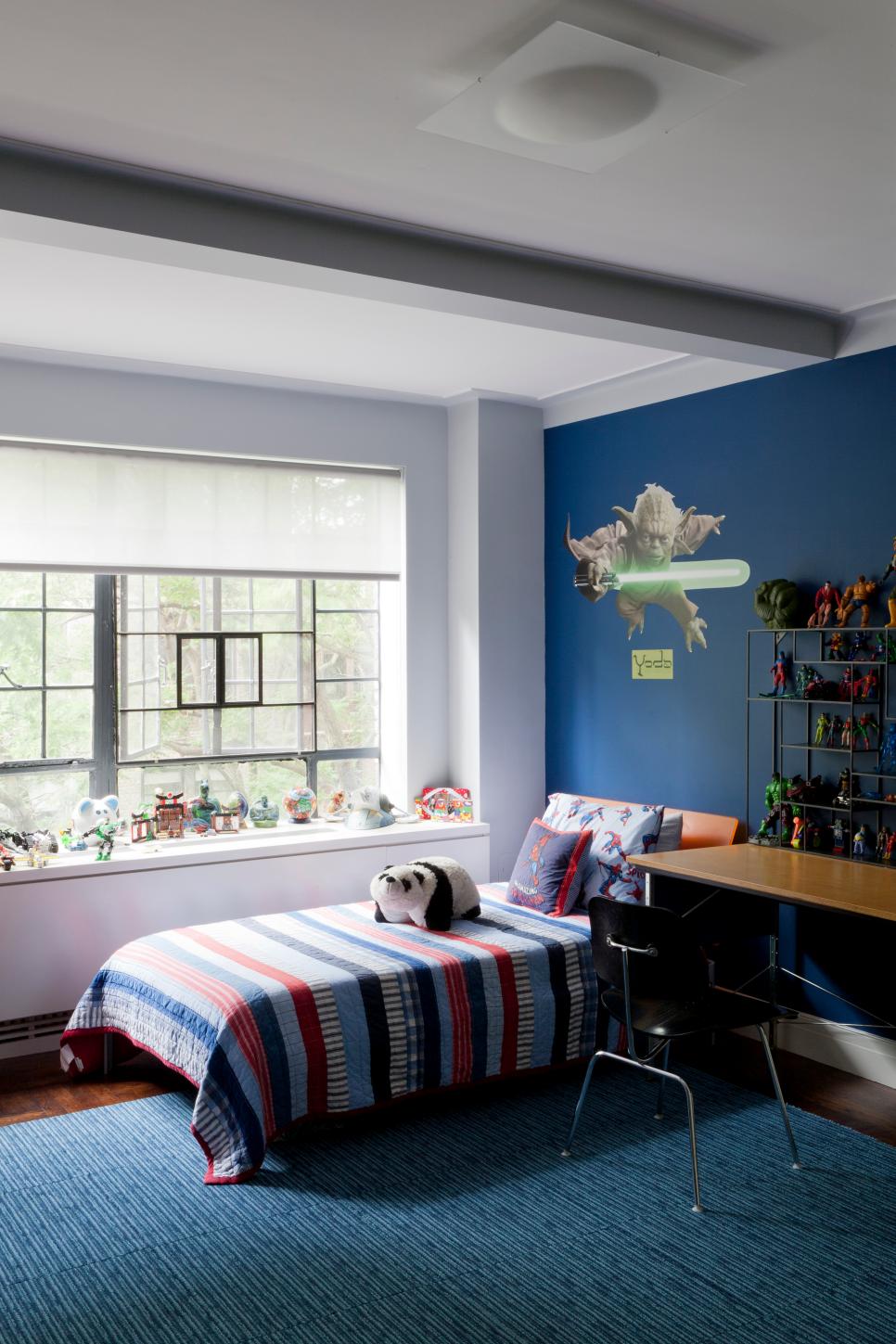 Blue Boy's Bedroom With Striped Comforter and Yoda Wall