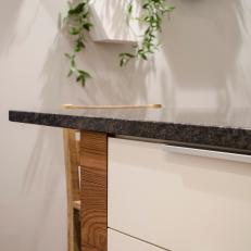 Kitchen Island With Black Granite Countertop and Wood Detail 