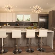 Neutral Modern Kitchen With Large Island and Starburst Pendant Lights 