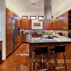 Modern Winery Kitchen With Wood Cabinetry & Brown Marble Flooring 