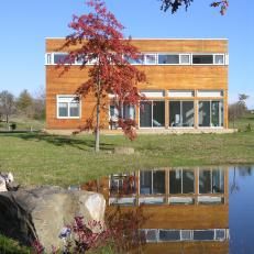 Contemporary Home Facade With Garden and Pond