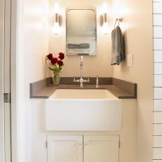 Small Bathroom's Retro Vanity Features Farmhouse Sink