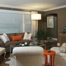 Orange Accents Brighten Brown Living Room