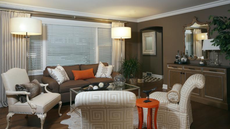 Brown Living Room With Floor Lamps, Neutral Armchair, Orange End Table