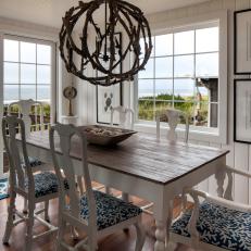 White Coastal Dining Room With Chandelier