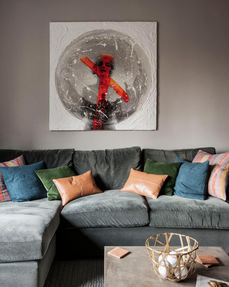 Artwork Above Gray Sectional With Multicolored Throw Pillows