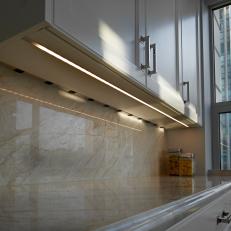 Stylish Kitchen Features Luxurious Marble Backsplash & Countertop With Hints Of Gold
