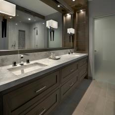 Double Vanity Bathroom Boasts Of Modern Faucets, Marble Countertop & Architectural Sconces