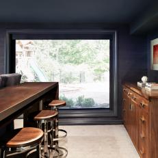 Gray Room With Wood Bar and Stools