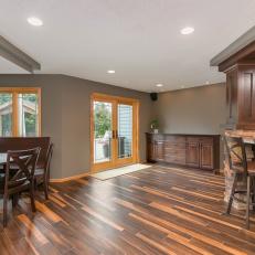 Transitional Basement With Unique Wood Floor Features Table, Seating & Bar