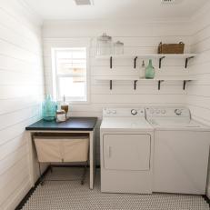 White, Cottage-Style Laundry Room With Penny Tile Floor