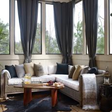 Gorgeous Contemporary Enclosed Porch With Bunch Gray Curtains, Animal Hide Rug and Wicker Sofa 
