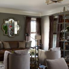 Transitional Living Room With Brown Leather Sofa, Mirroring Gray Bucket Chairs and Tall Display Shelf 