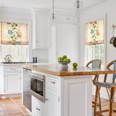 White Kitchen With Island and Floral Roman Shades