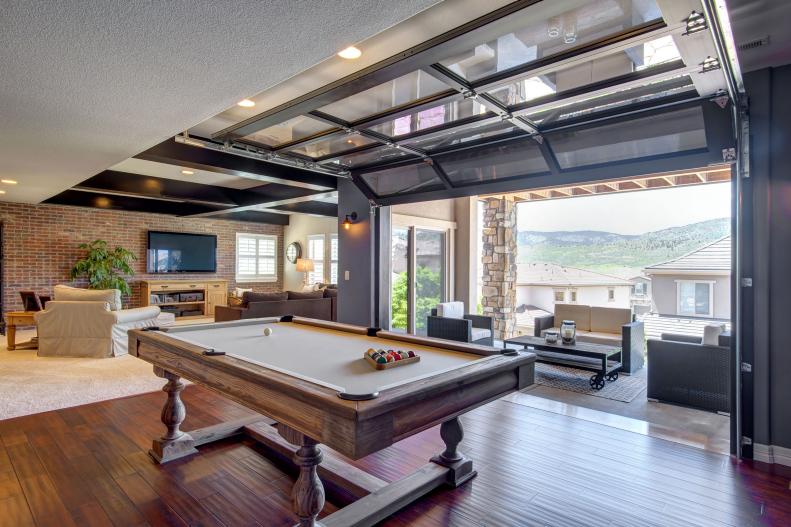 Basement With Pool Table and Garage Door Patio Access 