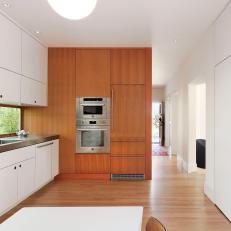 Bright, Modern Kitchen With White Laminate Cabinets, Vertical Woodgrain Room Divider Wall and Long Window 