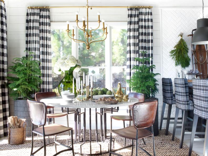 Homeowners looking for quick and easy ways to add warm holiday charm with little commitment may find that just a few simple accents of lush greenery and rich woods will do the trick. This dining room and kitchen was transformed by simply adding a pair of potted pine trees, tree cuttings and vintage wooden objects.