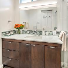 Contemporary Bathroom Vanity With Wood Cabinets, Thin Tile Backsplash Strip and Gray and White Countertop  