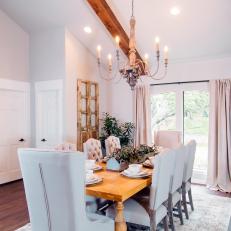 Spacious Dining Room With Upholstered White Chairs