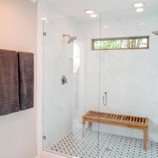 Glass Shower and Wooden Bench in Master Bathroom
