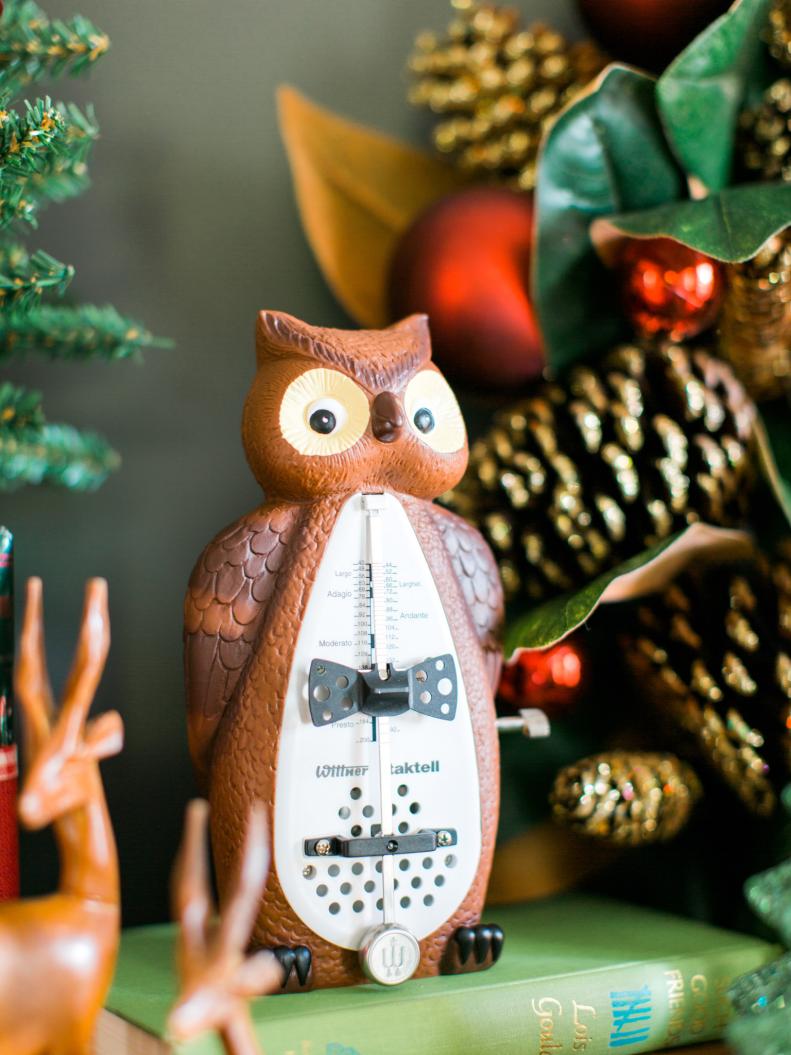 Incorporate music-related accents to your piano ensemble. Here an owl metronome used for keeping time sits front and center.