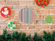When space is at a premium and there's no room for elaborate decorations, keep things simple, light and easy to store away with fabric-wrapped embroidery hoops. Choose a variety of fabrics in solid and patterned styles, cut them to size, then stretch them to the hoops. Arrange them randomly along the wall to add a pop of holiday cheer.