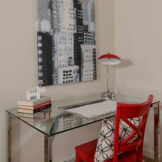 Glass-Top Desk With Bright, Red Chair and Red Hooded Table Lamp