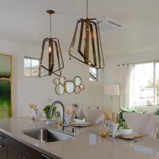 Fresh, Transitional Kitchen Design With Gold Contemporary Light Fixtures, Large Island With White Countertop and Green Accents