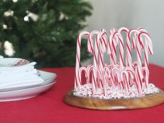 Traditional candy canes become an untraditional centerpiece decoration to modernize your table. First, hot glue unwrapped candy canes to the bottom of a wooden plate. Crush a few more candy canes and glue those pieces around the bottom of the standing canes.