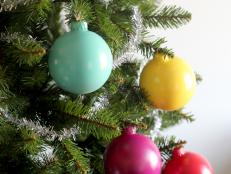 Bring a modern, colorful touch to a traditional Christmas tree with these candy colored glass ornaments. Simply spray paint round, glass ornaments with matte spray paint in bright colors. Mix with colored lights for a truly fun Christmas tree.