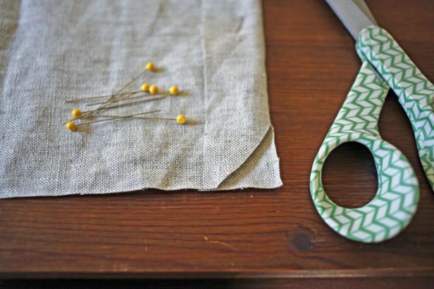 Cut the edge of the fabric piece to create a smooth corner.