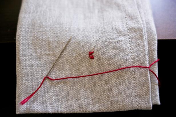To make a Scandinavian-inspired poinsettia napkin, cross-stitch &quot;X&quot;'s in a row
