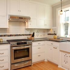 Bungalow Kitchen With White Cabinets and Subway Tile Backsplash