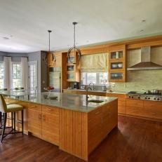 Open Contemporary Kitchen With Wood Floors and Cabinets