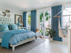 Inspired by the surrounding coastal color scheme, the terrace suite bedroom boasts breathtaking views and is the perfect space to tuck in after lounging by the pool.