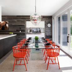 Contemporary Dining Area With Bold Orange Chairs