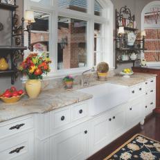 Traditional Kitchen With Arched Window and White Cabinets