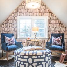 Library Inspired Eclectic Sitting Room With Bookshelf Wallpaper Accent Wall, Navy Striped Armchairs and an Animal Hide Rug 