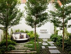 Contemporary New York Garden with Stone Pavers and a Fountain