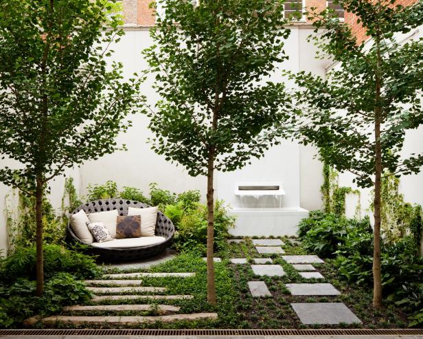 Contemporary New York Garden with Stone Pavers and a Fountain