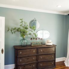 Dark Wood Dresser Adorned With Flowers in Master Bedroom